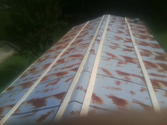 Rusted metal roof panels with new wood purlins before replacement — Storm Damage Roof Repair in Indiantown by Roofing Brothers