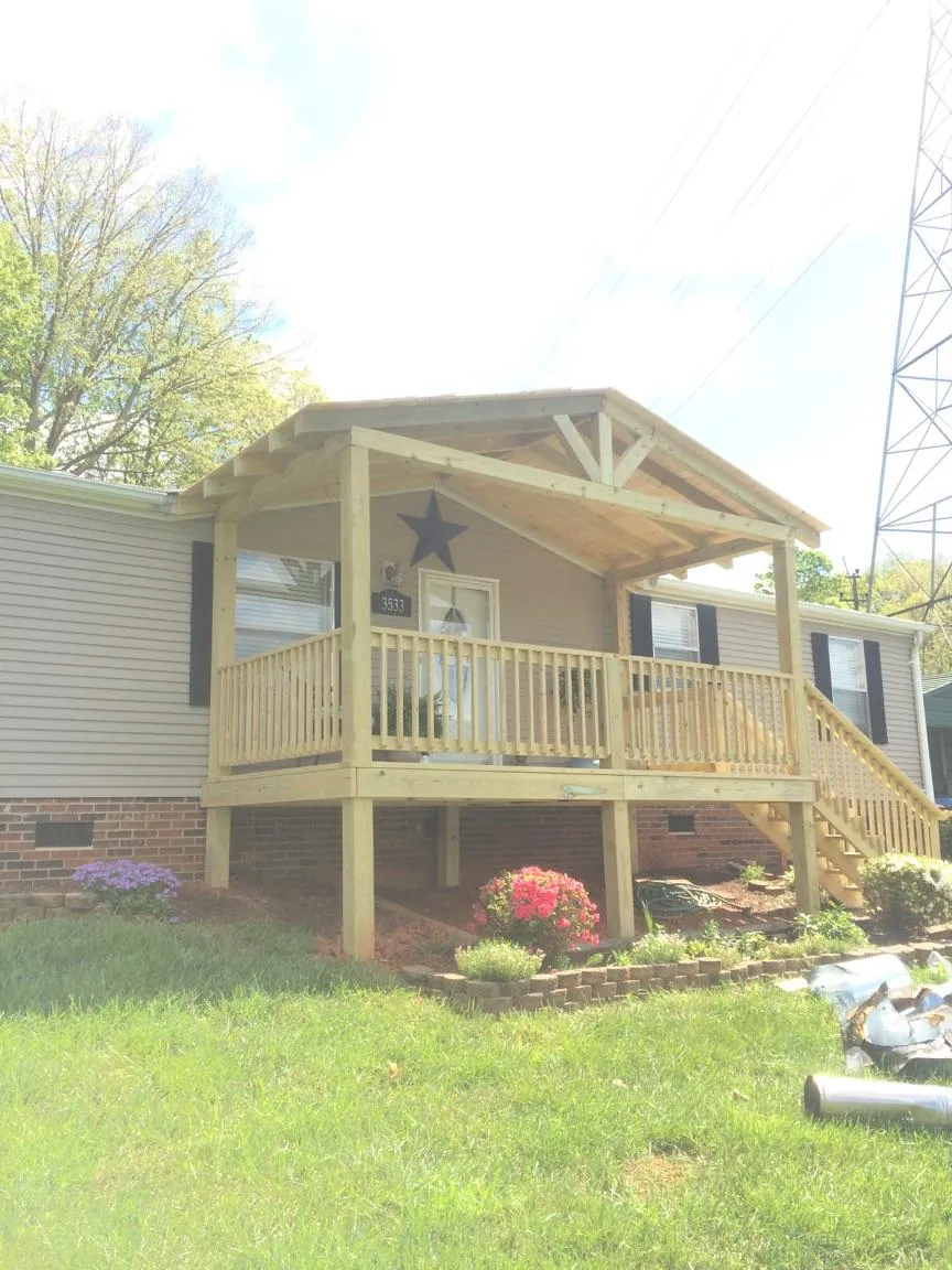 New gabled porch roof and deck railing added to a ranch home in Indiantown